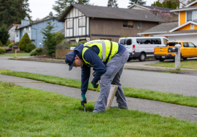 Field investigator checking a residential water meter.