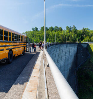 Cowlitz school tour shcool bus on top of the dam