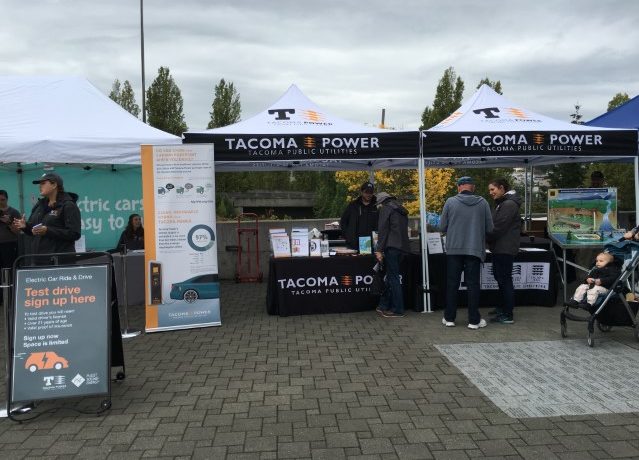 Image of a Tacoma Power booth promoting EV adoption.