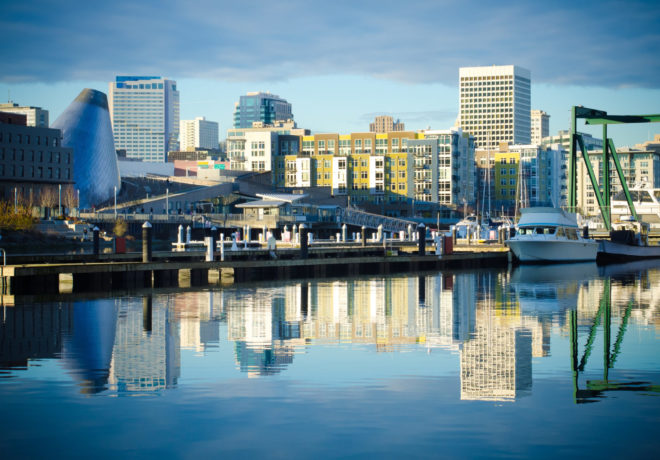Skyline consisting of office buildings, condominiums and museums of Tacoma, WA reflects off of the Foss Waterway.