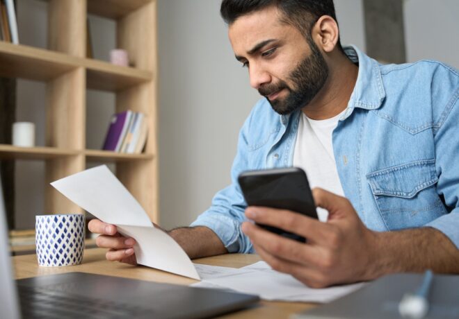 Young man reviewing a bill.