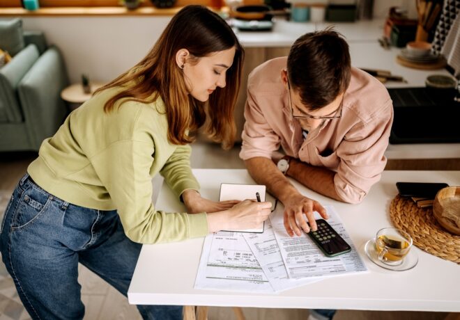 Young couple going over financial bills in their small apartment together