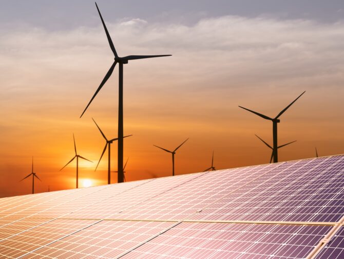 wind turbine and a solar panel at sunset.sustainable energy source for smart cities.