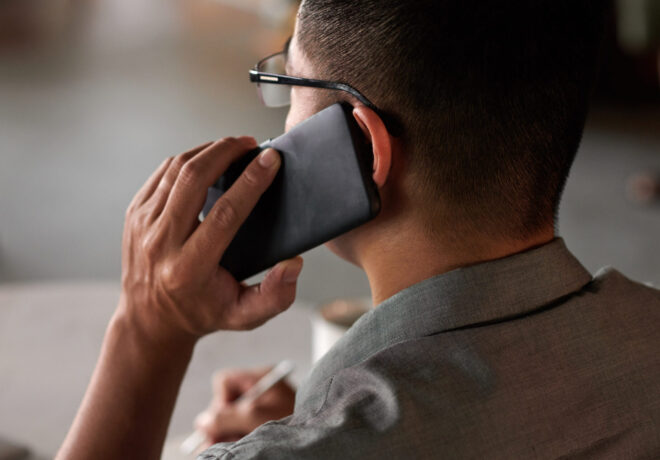 Photo of a man from behind, talking on cell phone