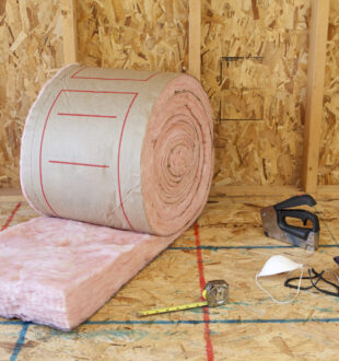 roll of insulation in surrounded by plywood and tools
