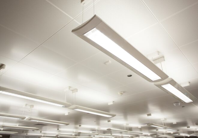 Image of indoor lighting hanging from a business office ceiling