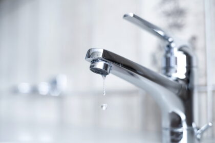 Dripping tap with water droplets