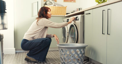 A basket, laundry and washing machine with woman in home for chores,