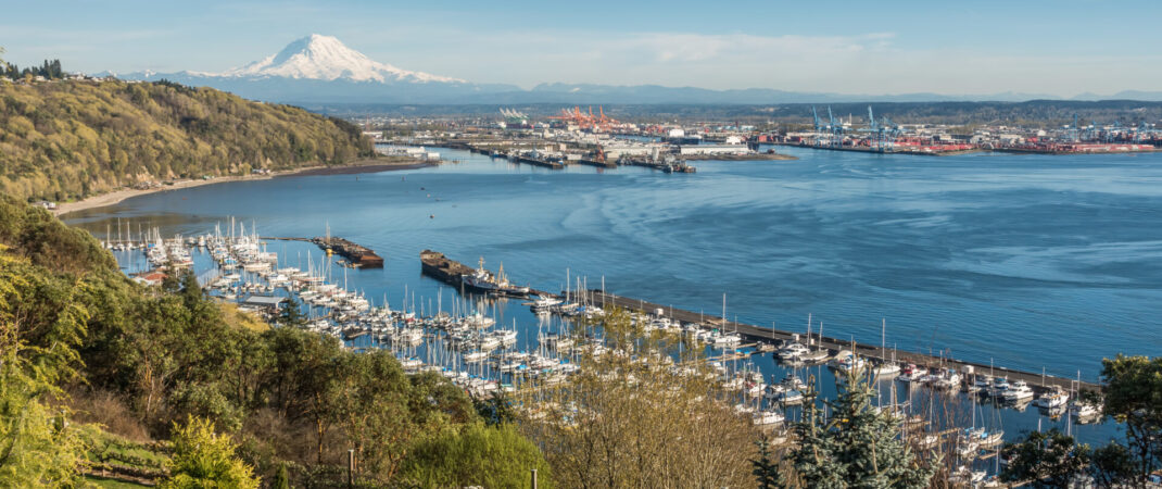A panoramic view of Mount Rainier, The Port of Tacoma and a marina.