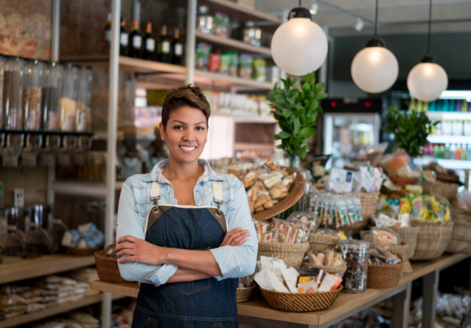 An image of a person working at a small grocery store