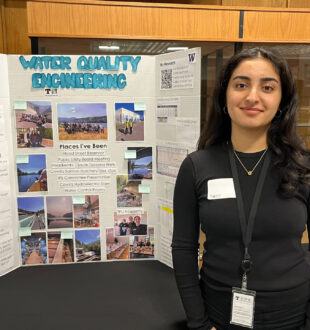 a young female-identifying adult standing in front of a poster that reads water quality engineering