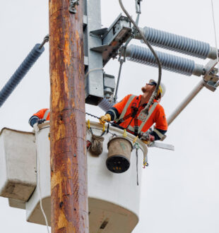Image of a line apprentice in a bucket installing an electrical switch