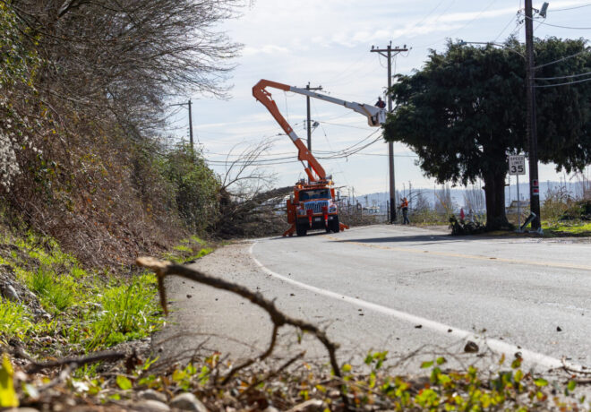 Tacoma Power crews in a bucket truck repairng a power line.