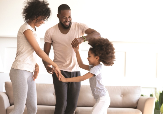 Family dancing together in their living room