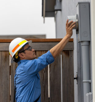 Image of a meter apprentice installing a meter on a residential property