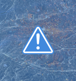 Alert icon in front of blue water