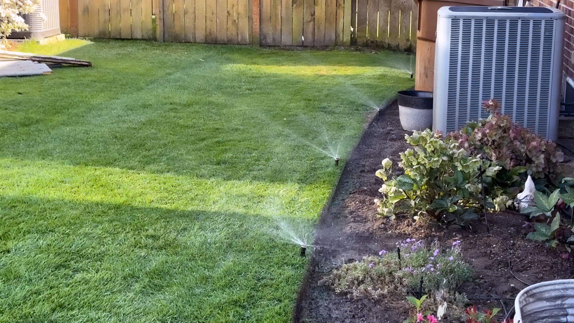 beautiful lawn with a smart irrigation system watering it.
