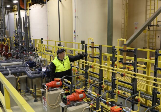 Tacoma Water employee stands in the Green River filtration facility surrounded by advanced water testing equipment.