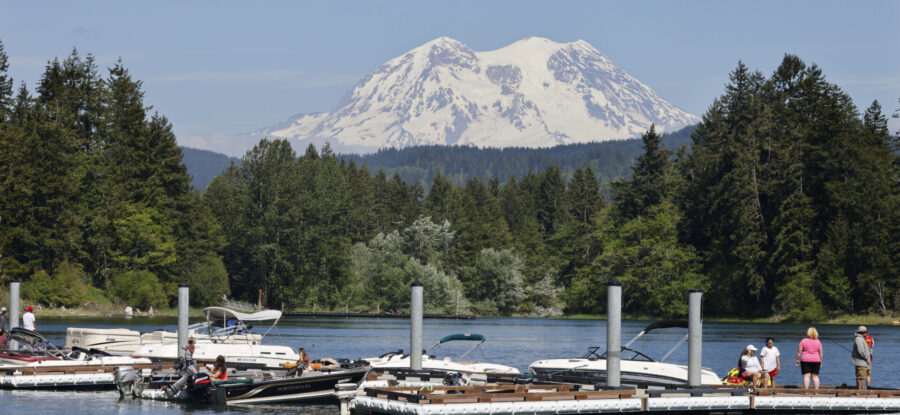 Alder Lake with boats, a dock, and mountain in the background