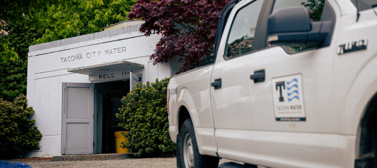 Tacoma Water service truck parked outside a Tacoma City Water well building.
