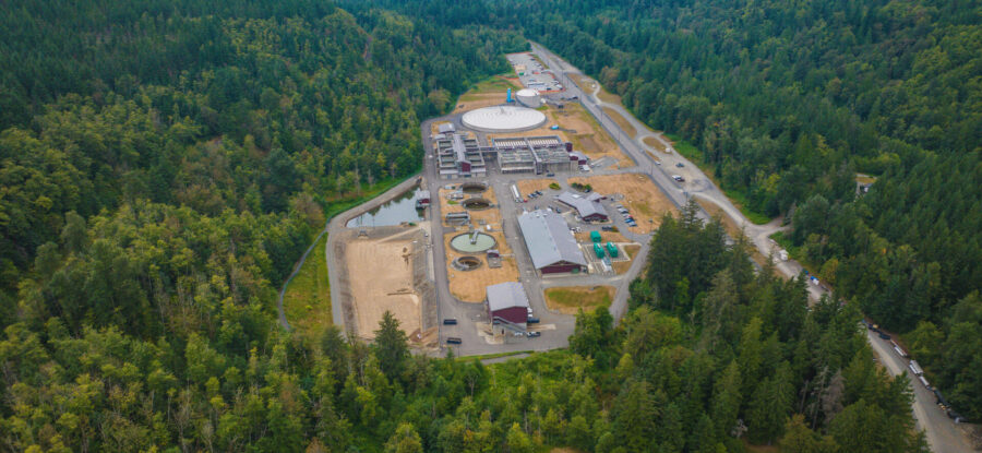 Aerial view of a water treatment facility surrounded by dense forested hills in the Green River watershed.